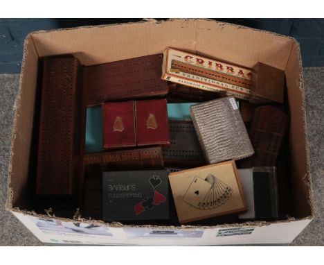 A box containing large quantity of cribbage boards. Including oak, metal examples, etc.  