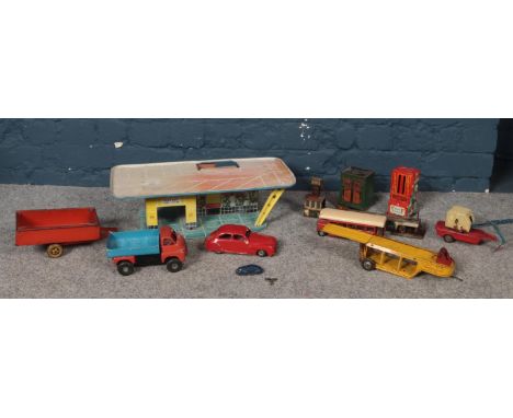 A group of tinplate toys. Shell model garage, Mimic toys bus &amp; Truck, Chocolate Slot Machine, car transporter etc  