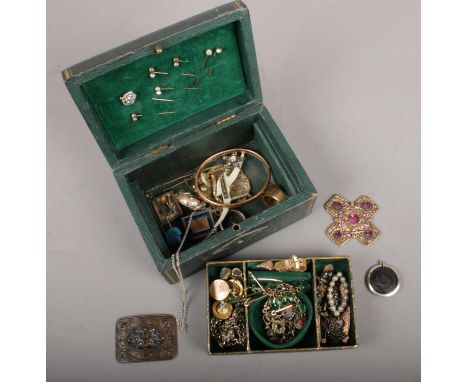 A jewellery box with contents of vintage costume jewellery. Includes rings, stick pins, yellow metal bracelet etc.  