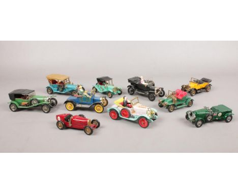 A group of die cast vehicles. Dinky Toys 1913 Morris Oxford, Dinky Toys 475 Model T Ford, Corgi Classic's 1915 Ford Model T e