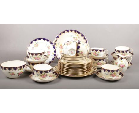 A Royal Crown Derby part tea set. cups/saucers, milk jug, sugar bowl, side plates etc.  Various pieces tobacco stained