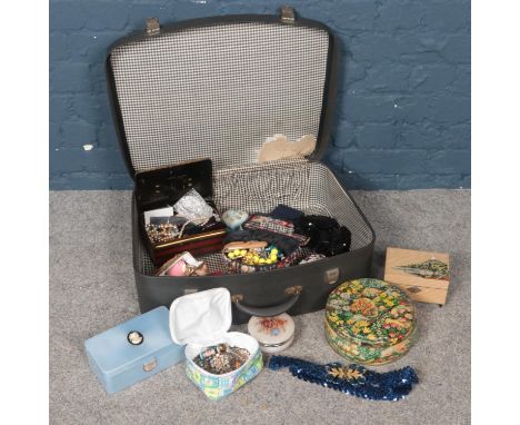 A vintage suitcase to include a group of costume jewellery. Beads, necklaces, brooches etc.  