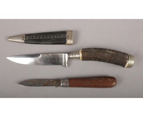 A vintage German hunting knife along with a pen knife. The hunting knife etched to the blade Central Verband 1914 Germanentro
