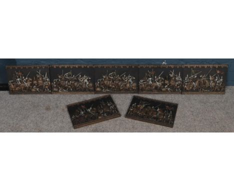A set of seven medieval battle scene ceramic wall plaques by Marcus Designs.  