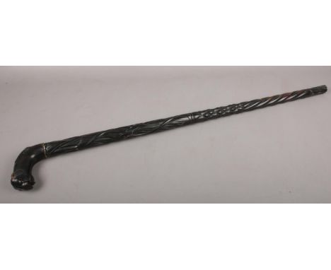 A carved African ebonised walking stick. With elephant mask handle.  Handle broken.