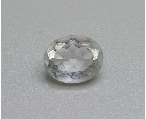 A collection of very small unmounted diamonds and an unmounted light blue stone 