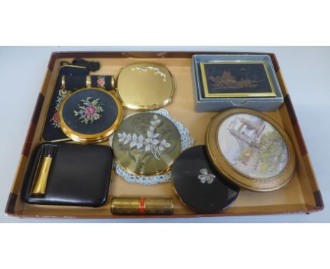 A collection of vintage compacts, a needlepoint compact lipstick, Stratton comb, large clover musical Tower of London mascot 