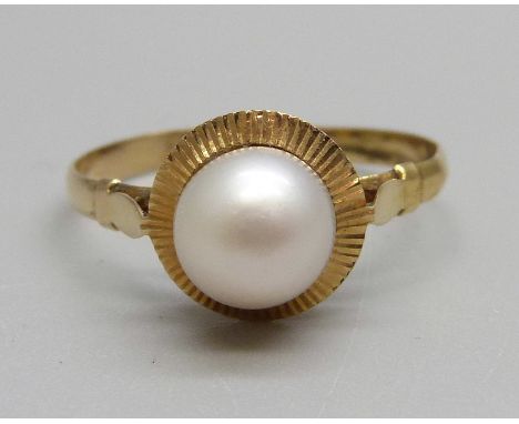 A yellow metal and pearl ring, control marks on the outside of the shank, tests as 18ct gold, 1.5g, O 