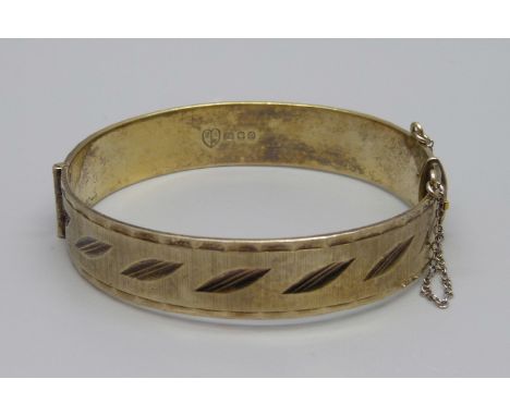 A silver gilt bangle, London 1969, marked '22ct on silver', 28.8g, Fred Manshaw Ltd. 