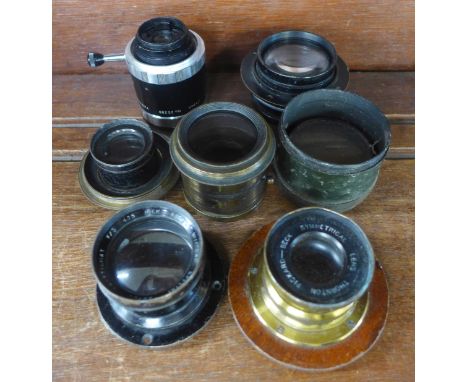 Seven vintage magic lantern/camera lenses including two gilt brass 