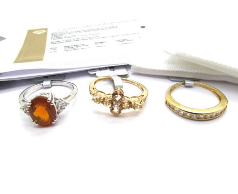 The Genuine Gemstone Company; A 9ct Gold Ouro Preto Imperial Topaz & White Zircon Ring, of floral design (finger size N1/2); 