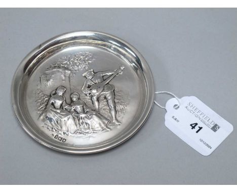 An Edwardian Hallmarked Silver Decorative Dish, W.C, London 1905, depicting two seated crinoline ladies with a guitar player,