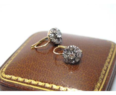 A Pair of Antique Old Cut Diamond Set Earrings, of flowerhead cluster design, circular claw set throughout to hinge top backs