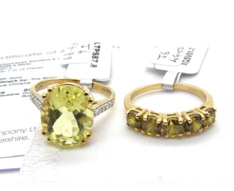 The Genuine Gemstone Company; A 9ct Gold Chartreuse Sanidine & White Zircon Ring, the oval centre stone double claw set betwe