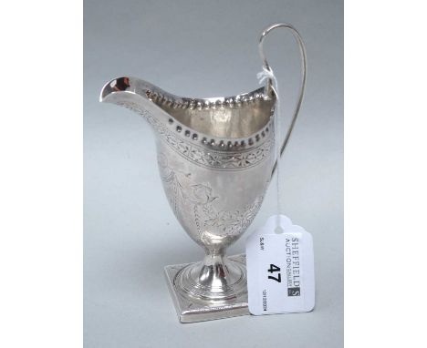 A Georgian Hallmarked Silver Cream Jug, AB, London 1793, chased decorative foliage engraving throughout, with capped sinuous 