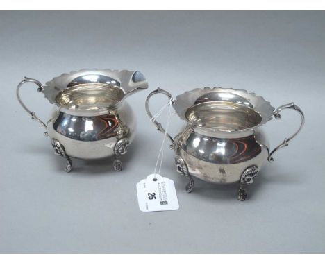 A Decorative Twin Handled Sugar Bowl, with wavy cut rim, scroll capped handles and raised on four lion mask capped paw feet, 