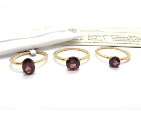 The Genuine Gemstone Company; A Set of Three 9ct Gold Umbalite Single Stone Stacker Rings, including oval and round claw set 