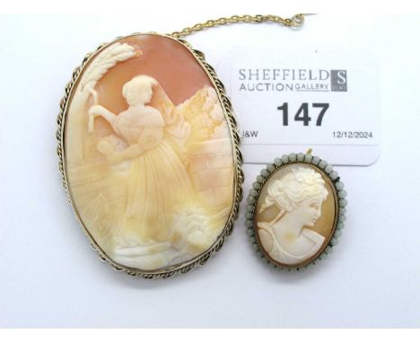 An Antique Style Large Carved Shell Cameo Brooch, depicting a courtyard scene with lady picking wheat, livestock and trees, w