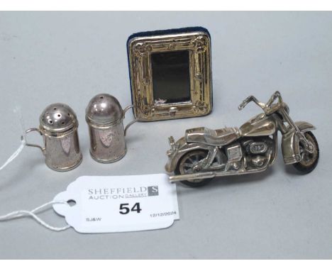 A Hallmarked Silver Novelty Motorbike, together with a hallmarked silver mounted miniature photograph frame, overall height 4