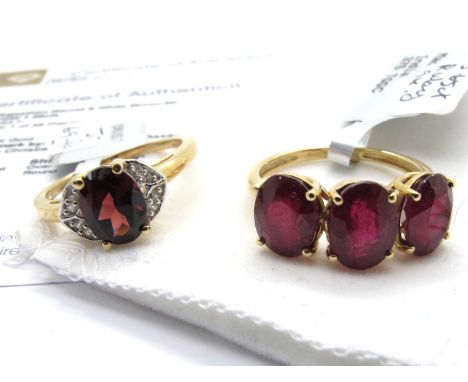 The Genuine Gemstone Company; A Rajasthan Garnet & White Zircon Single Stone Ring, oval claw set between stone set crescent s