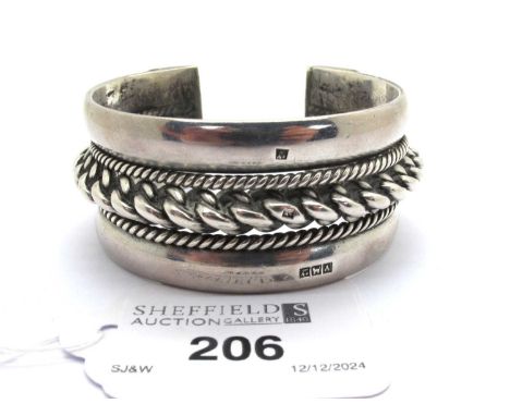 A Wide Cuff Style Bangle, with rope twist detail, indistinctly stamped (116grams).