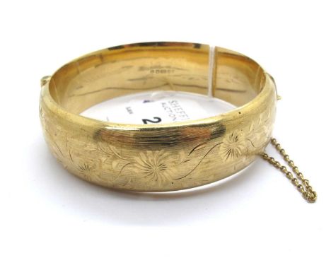 A 9ct Gold Vintage Hinged Bangle, of allover floral decoration with brushed finish, to snap clasp and safety chain, approxima