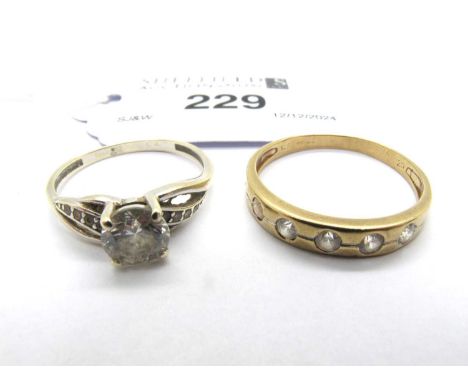 A Half Eternity Style Ring, cubic zirconia set, stamped "375" (finger size U), together with a four claw set ring, between in