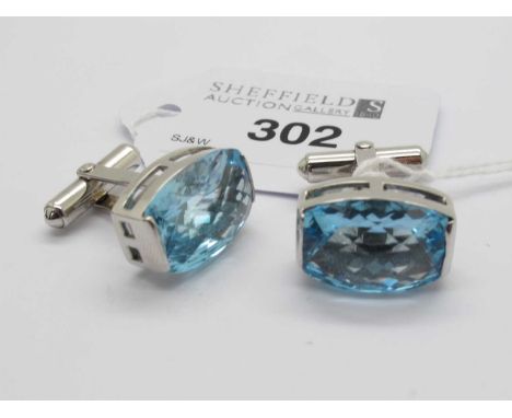 A Pair of Faceted Stone Set Cufflinks, of shaped oval form, on panel link connectors to swivel backs, stamped "9K" (white).