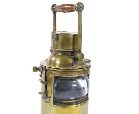 A heavy gauge brass lantern with bull's eye lens and swing handle, height 34cm 