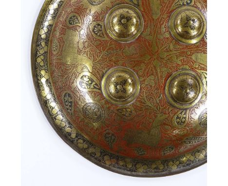 An Islamic engraved brass and enamel shield, diameter 37cm 