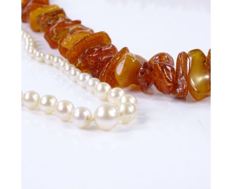 A graduated single-strand pearl necklace, together with a graduated string of Baltic amber (2) 