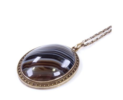 A large Victorian unmarked yellow metal banded agate memorial pendant necklace, with decorative hair and split-pearl reverse,