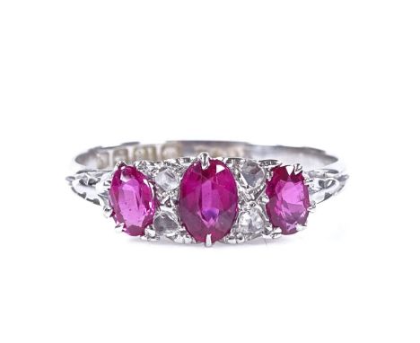 An Edwardian 18ct white gold 7-stone ruby and diamond half-hoop ring, with engraved bridge and shoulders, hallmarks Birmingha