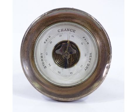 A silver-framed desk barometer with oak back, hallmarks Birmingham 1924, 10cm across 