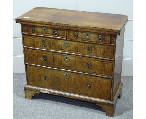 A 19th century walnut bachelor's chest of drawers of small size, in Georgian style, with crossbanded fold over top, brass dro