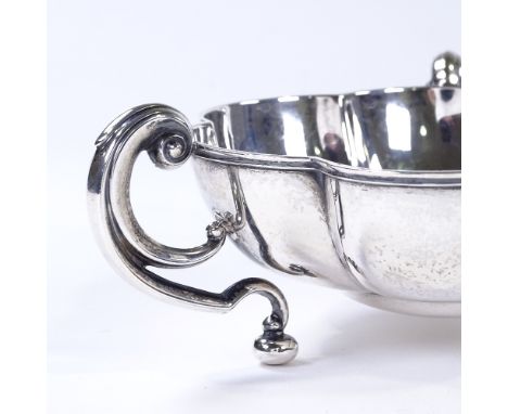 An Edwardian circular silver lobed bowl, with 3 C-handles, by Horace Woodward &amp; Co for Mappin &amp; Webb, hallmarks Birmi