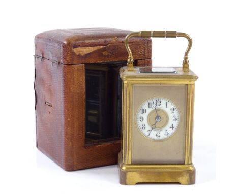 A small French 8-day brass-cased carriage clock, enamel dial, striking on a gong, case height 10cm, leather travelling case 