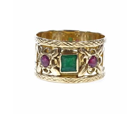 An unmarked gold 3-stone emerald and ruby band ring, with pierced settings and lattice border, band width 10.9mm, size N, 5g 