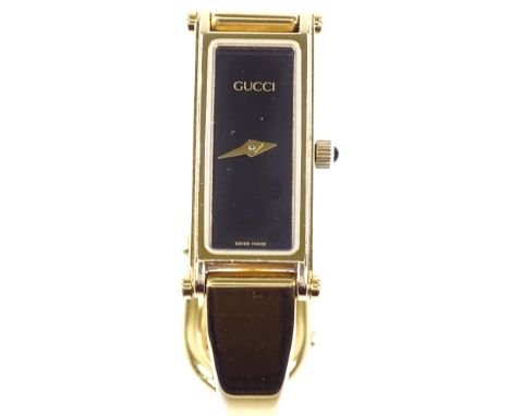 GUCCI - a lady's gold plated 1500 bangle quartz wristwatch, black face with rectangular case, case no. 0419382, case width 12