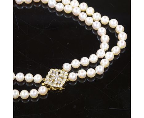 A double-strand choker pearl necklace, with 18ct gold diamond set flowerhead clasp, pearl diameter 5.9mm, necklace length 14"