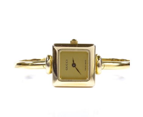 GUCCI - a lady's gold plated 1900L bangle quartz wristwatch, square champagne dial, case no. 0182271, case width 19mm, workin