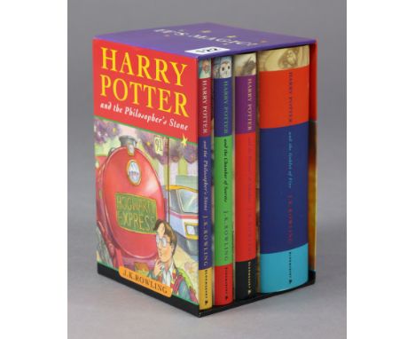 A set of four “Harry Potter” hard-back books by J. K. Rowling, published by Bloomsbury, with cardboard box case. 