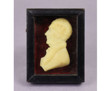 A 19th century wax relief portrait of Rev. John Huyshe in an ebonised rectangular frame, 3¾” x 3” over-all.