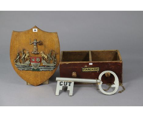A painted cast-metal crest of Southampton mounted on an oak shield-shaped plaque, 17¾” x 14¼”; together with a locksmith’s no