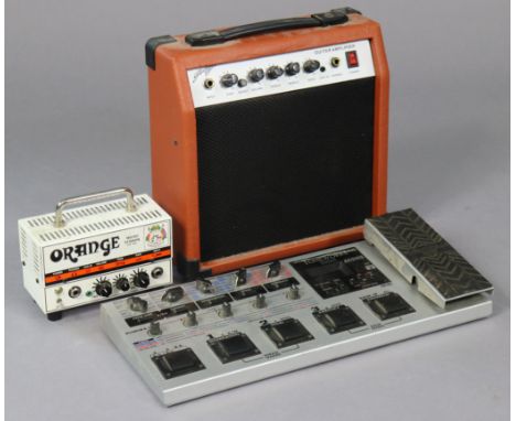 A Tone Works Korg “AX1500G” modelling signal processor; &amp; orange “Micro Terror” amplifier; &amp; a practice amplifier.