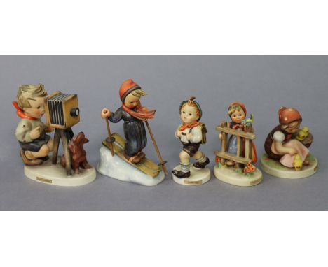 Five Goebel Hummel figures “Chick Girl”; “School Boy”; “Signs of Spring”; “The Photographer”; &amp; “Skier”; the latter w.a.f