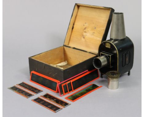 An early 20th century German magic lantern in a painted deal box; &amp; thirteen various coloured slides. 