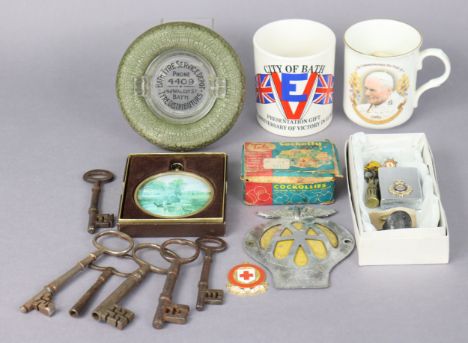 An “AA” car membership badge; a Zippo lighter; a British Red Cross Society First Aid medal; two commemorative mugs, etc.