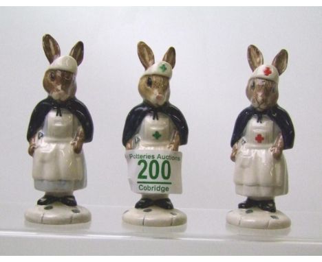 Royal Doulton Bunnykins figures to include: Nurse DB74A, 74B and 74 no cross (rare)(3) 