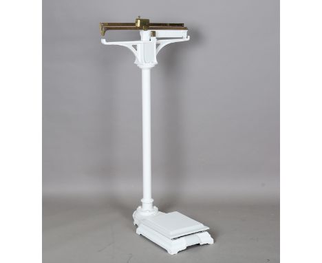 A set of late 19th century cast iron and brass mounted floor standing scales, height 125cm.Buyer’s Premium 29.4% (including V